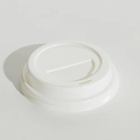 White takeaway coffee cup lid on a light gray background