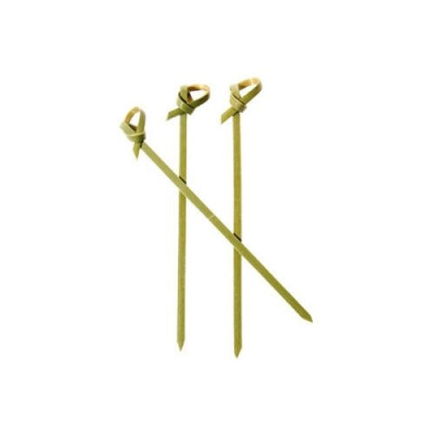 Three green skewers with decorative ends on a white background