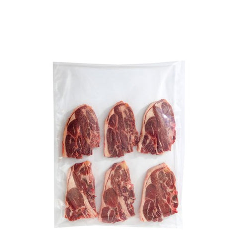 Six raw meat pieces in a vacuum seal bag on a white background