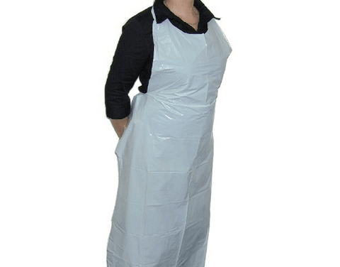 Person wearing a white disposable apron over a black shirt on a white background