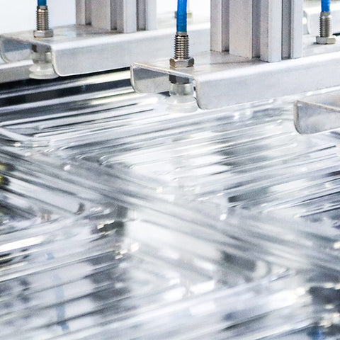 Close-up of a plastic lids being stacked after moulding 