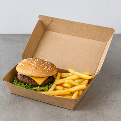 Burger and fries in a cardboard snack box on a gray surface