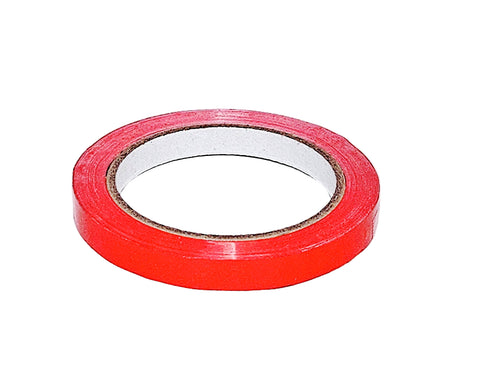 Roll of red PVC tape on a white background
