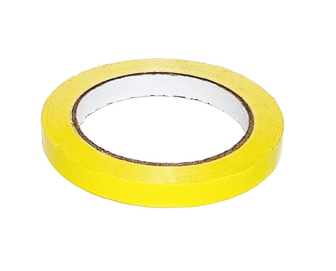 Roll of yellow PVC tape on a white background