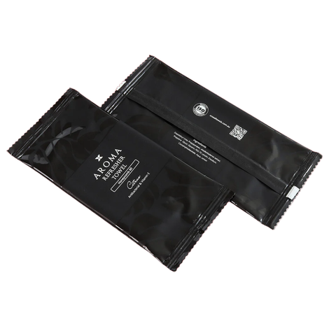 Two black Aroma Refreshment Towel packages on a white background