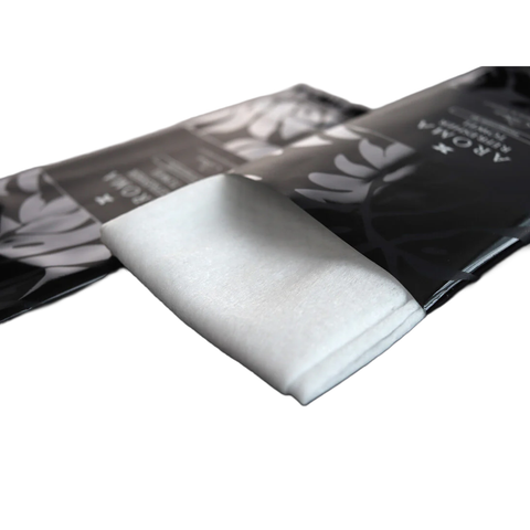White refresher towel with black packaging featuring 'AROMA' branding on a white background